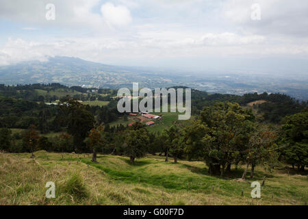 Rolling farmland on the hillside beaneath the Poas Volcano in Costa Rica. Stock Photo