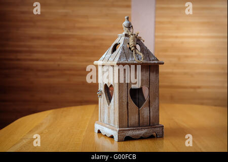 White lantern with flowers on wooden table, close-up Stock Photo