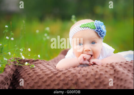 Cute little girl on the meadow in summer day Stock Photo