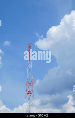 Common communication tower,cell tower, cellphone tower under construction against blue sky and clouds. Stock Photo