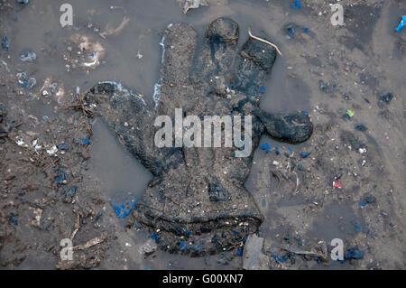 France, Calais. 'Jungle' camp for refugees. A lost glove in the mud Stock Photo