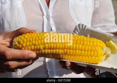 Eating corn with butter Stock Photo