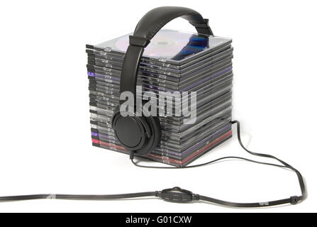 Black headphones on a pile of CD on a white background Stock Photo