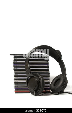 Black headphones on a pile of CD on a white background Stock Photo