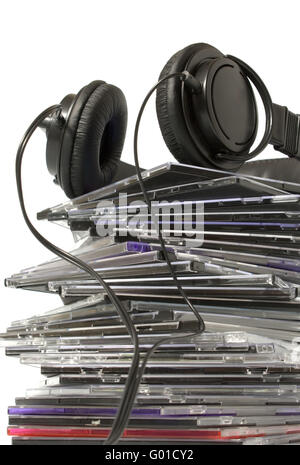 Black headphones on a pile of CD on a white background Stock Photo
