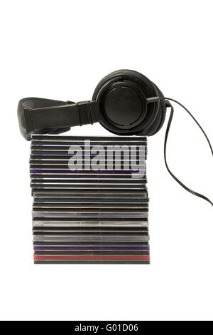 Black headphones on a pile of CD on a white background Stock Photo