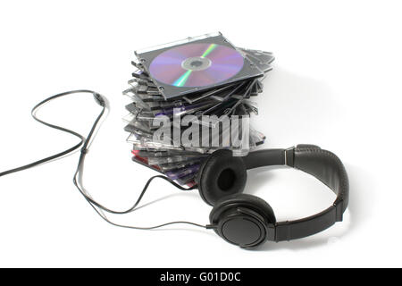 Black headphones on a pile of CD on a white background Stock Photo