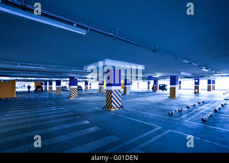 View to empty parking with several autos in blue Stock Photo