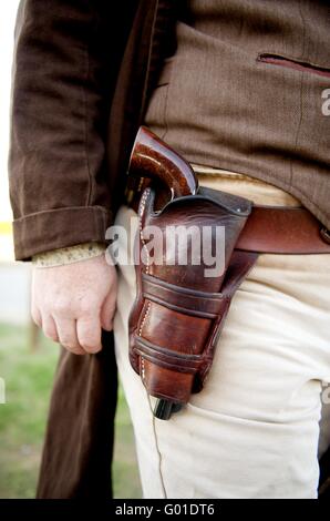 Image close up of a gun in a holster strapped to a Stock Photo