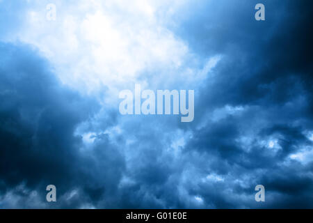 dark blue cloudly sky with ray of sunlight after storm Stock Photo