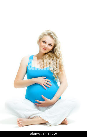 young pregnant caucasian woman posing in the studio Stock Photo