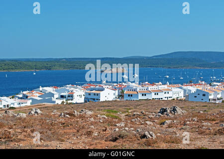 Menorca, Balearic Islands, Spain: sailboat at the entrance of the port of the fishing village of Fornells, located in a bay in the north of the island Stock Photo