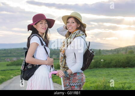 Girlfriends standing on the middle of the road Stock Photo