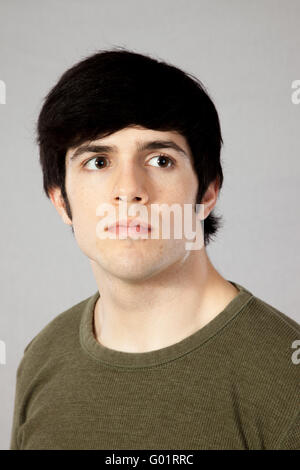 Handsome man with black hair, looking to the right thoughtfully Stock Photo