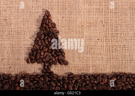 Christmas tree made from roasted coffee beans on a burlap background Stock Photo