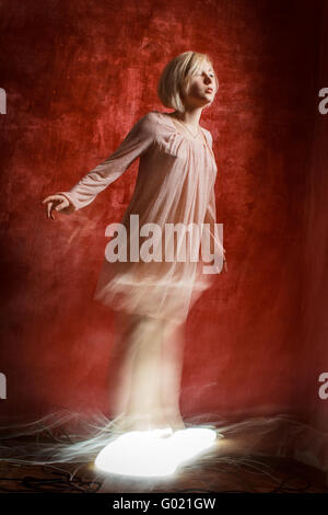 Ghost digital girl on red grunge wall Stock Photo