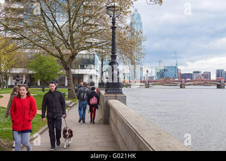 People walking along the river Thames on Albert Embankment in London England United Kingdom UK Stock Photo