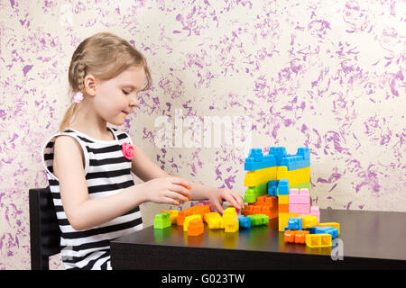 little-girl-builds-bricks-at-the-table-stock-photo-alamy