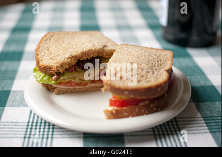 whole wheat sandwich on checkered table cloth Stock Photo