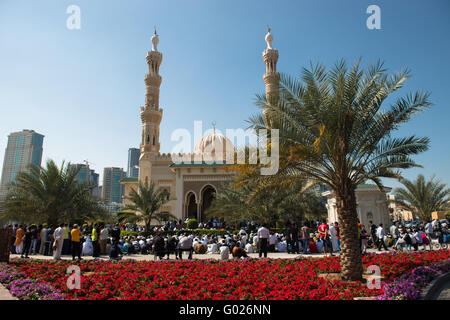 Worshiping outside a mosque, Emirate of Sharjah, UAE. Stock Photo