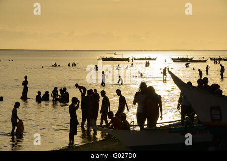 Crowds of people in ocean Stock Photo