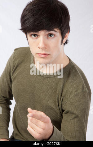 Handsome man  with a pensive expression and pointing his finger at the camera Stock Photo