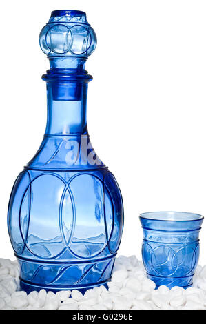 Beautiful blue bottle and tumbler on white stones Stock Photo
