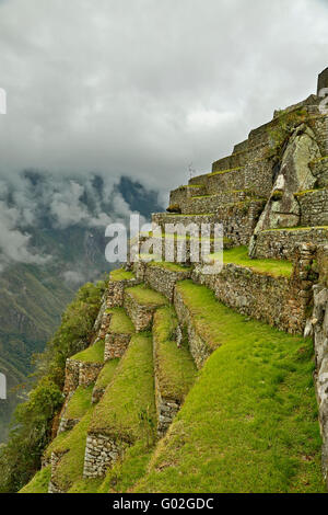 Agricultural terraces on cliff side, Machu Picchu Inca ruins, near Aguas Calientes, aka Machu Picchu Pueblo, Cusco, Peru Stock Photo