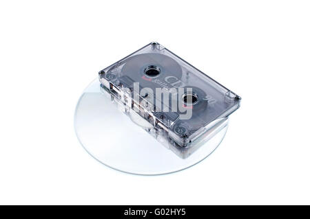 Analog audio tape cassette and digital compact disc on  white background Stock Photo