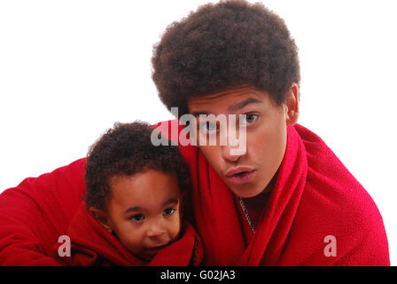Multi-racial baby and his brother wrapped in a blanket Stock Photo