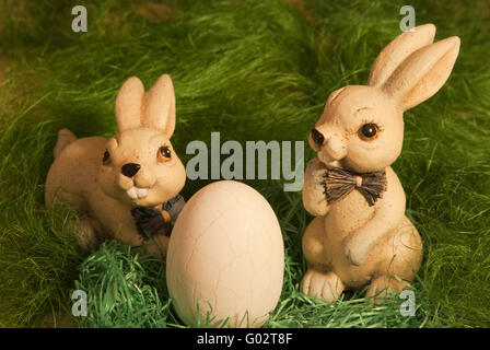 Easter Bunny with egg in the nest Stock Photo