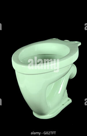 The light green toilet bowl, isolated on black background Stock Photo