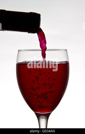 red wine pouring down from a wine bottle Stock Photo