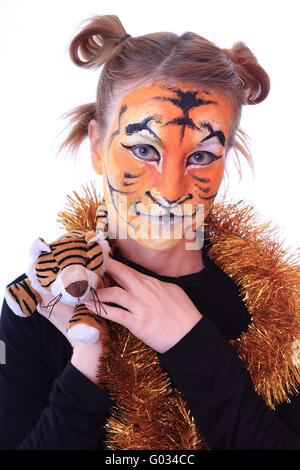 Girl in appearance a tiger with a toy tiger cub. Stock Photo