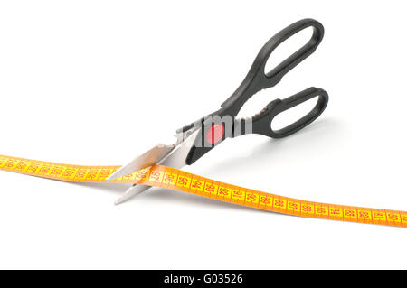 scissors cutting a measuring  on white background Stock Photo