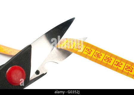 scissors cutting a measuring  on white background Stock Photo