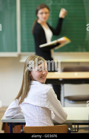 School child with a teacher in the classroom. Stock Photo