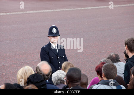 British policeman observes crowd Stock Photo