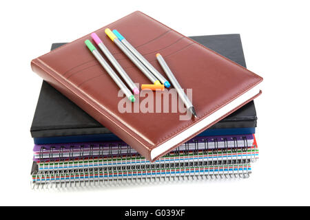 Felt-tip pen on a pile of writing-books and organizers Stock Photo