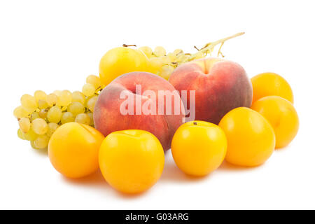 Two peaches, yellow plums and grapes branch on whi Stock Photo