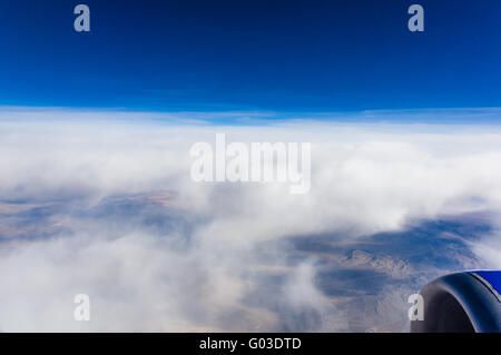 White clouds show off a deep blue sky seen from a passenger jet over Nevada Stock Photo