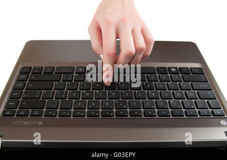 female hand pushing a button on laptop keyboard with the finger Stock Photo