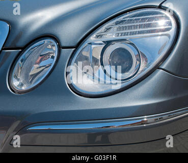 circular car head lights on a gray metallic sports car Stock Photo