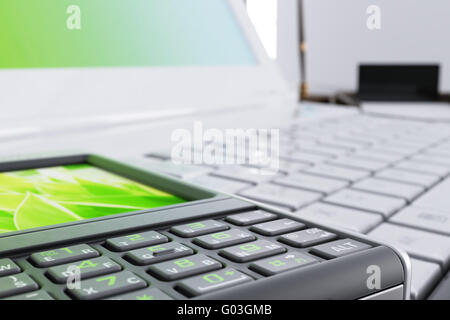 mobile phone lies on the laptop at modern office Stock Photo
