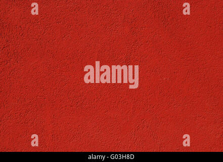 Red painted plastered house wall as background Stock Photo