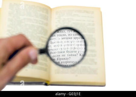 open book under a magnifying glass isolated on whi Stock Photo