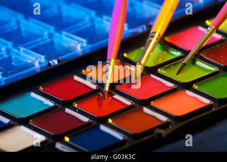 Palette of watercolor paints with three brushes Stock Photo