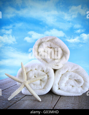 Fluffy fresh towels against a blue sky with clouds Stock Photo