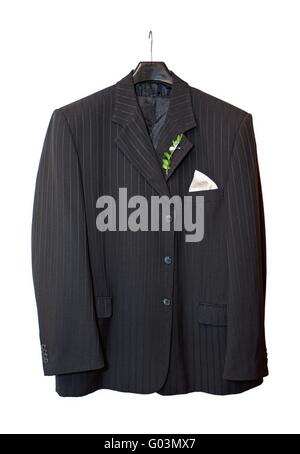 Suit jacket hanging on a hanger with a boutonniere in place on white background Stock Photo