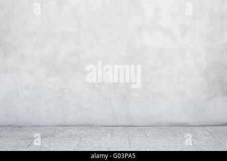 Gray cement wall with empty stone tiled floor Stock Photo